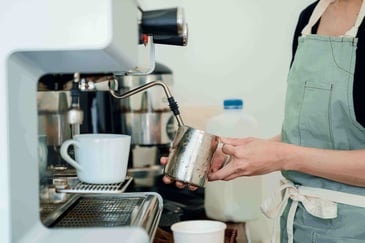 A person making an espresso