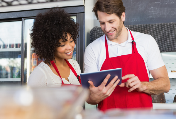 Restaurant servers looking at tablet. 