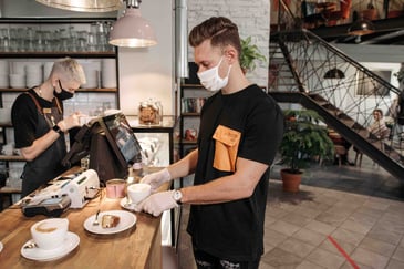 An employee prepping a coffee