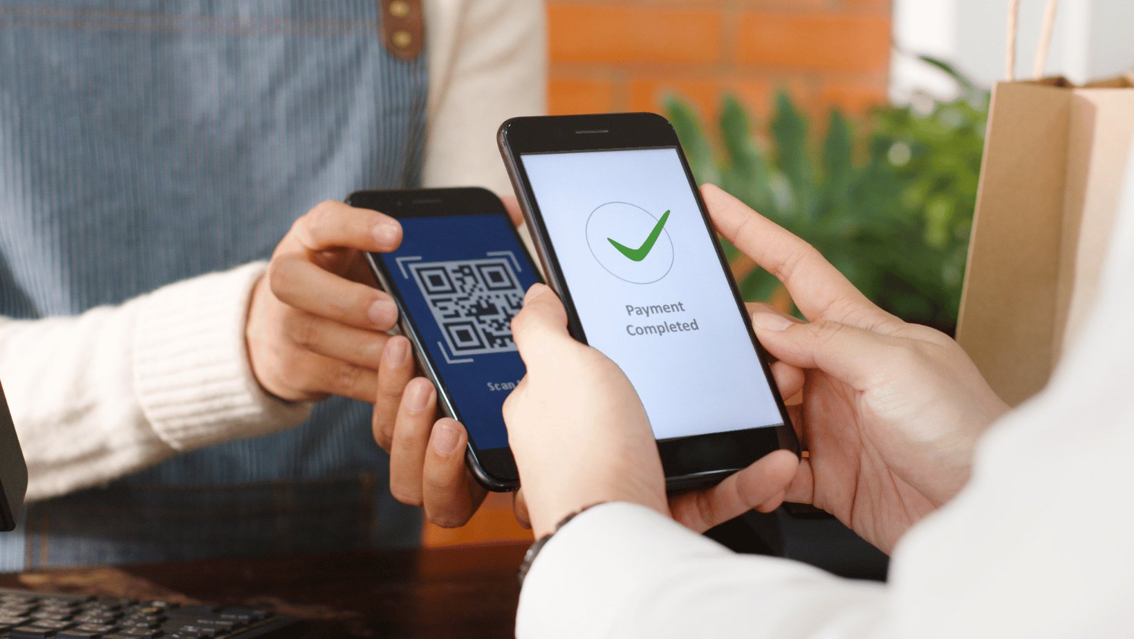 Customer using phone for QR code payment at restaurant. 