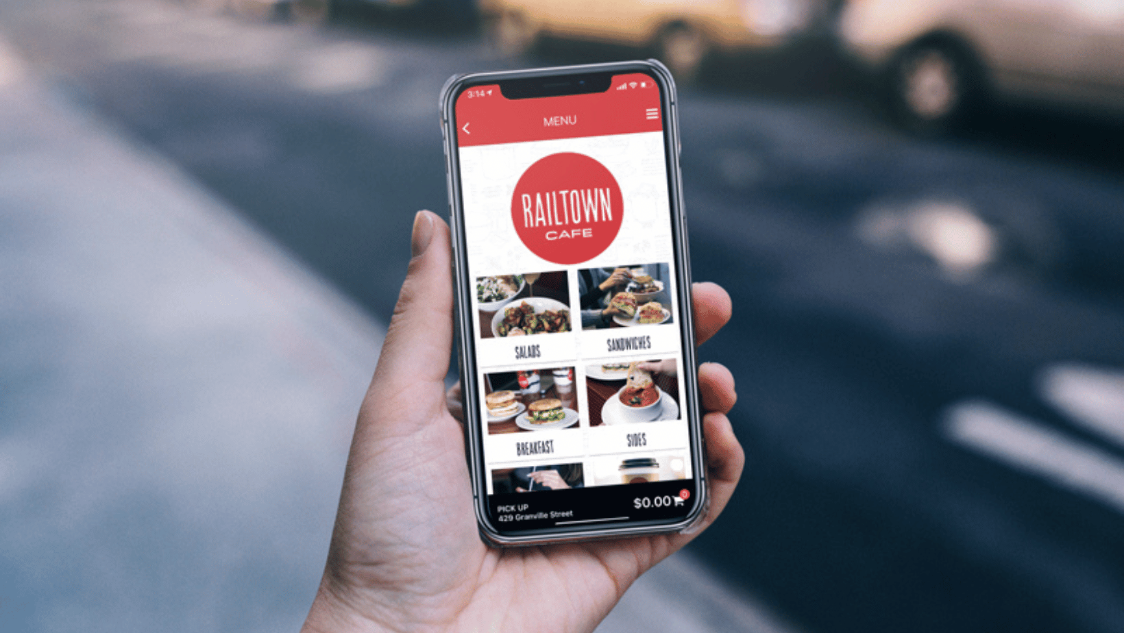 Person holding phone with Railtown Cafe's app open. 