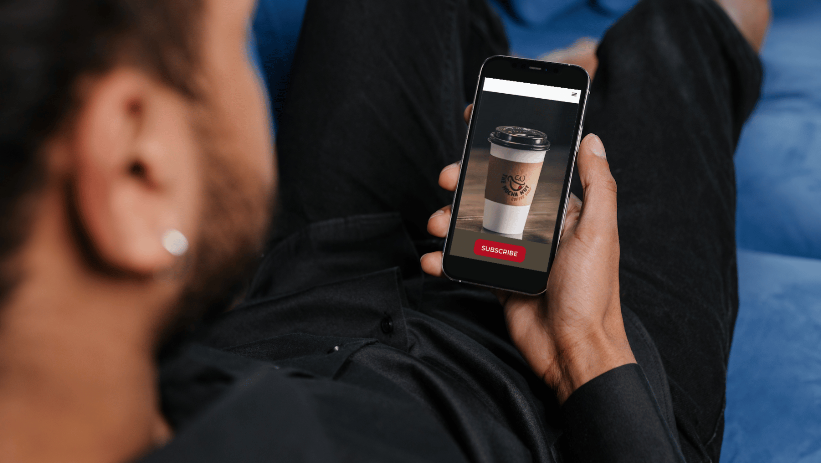 Man holding phone with restaurant subscription app open. 