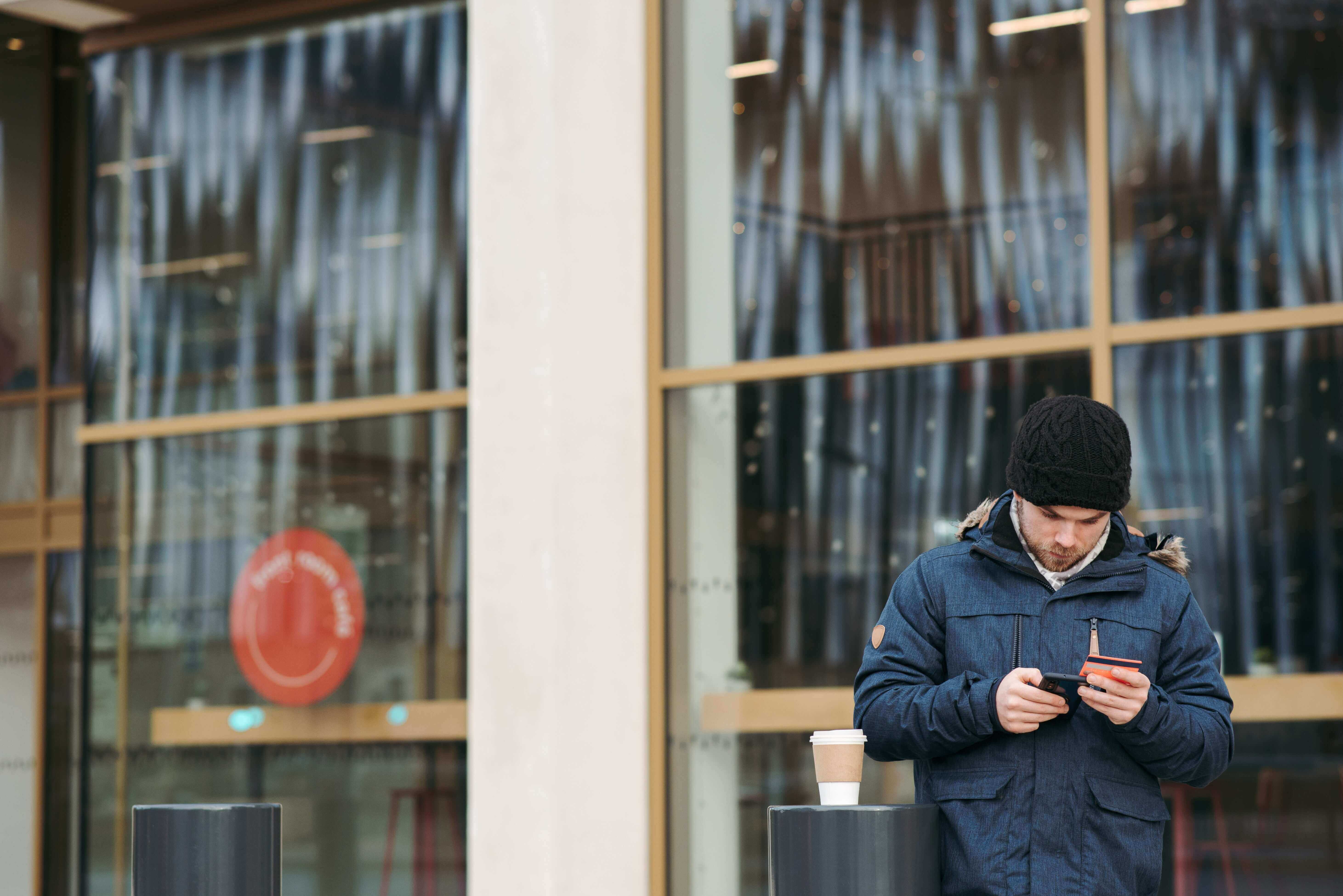 A man ordering a coffee on his phone