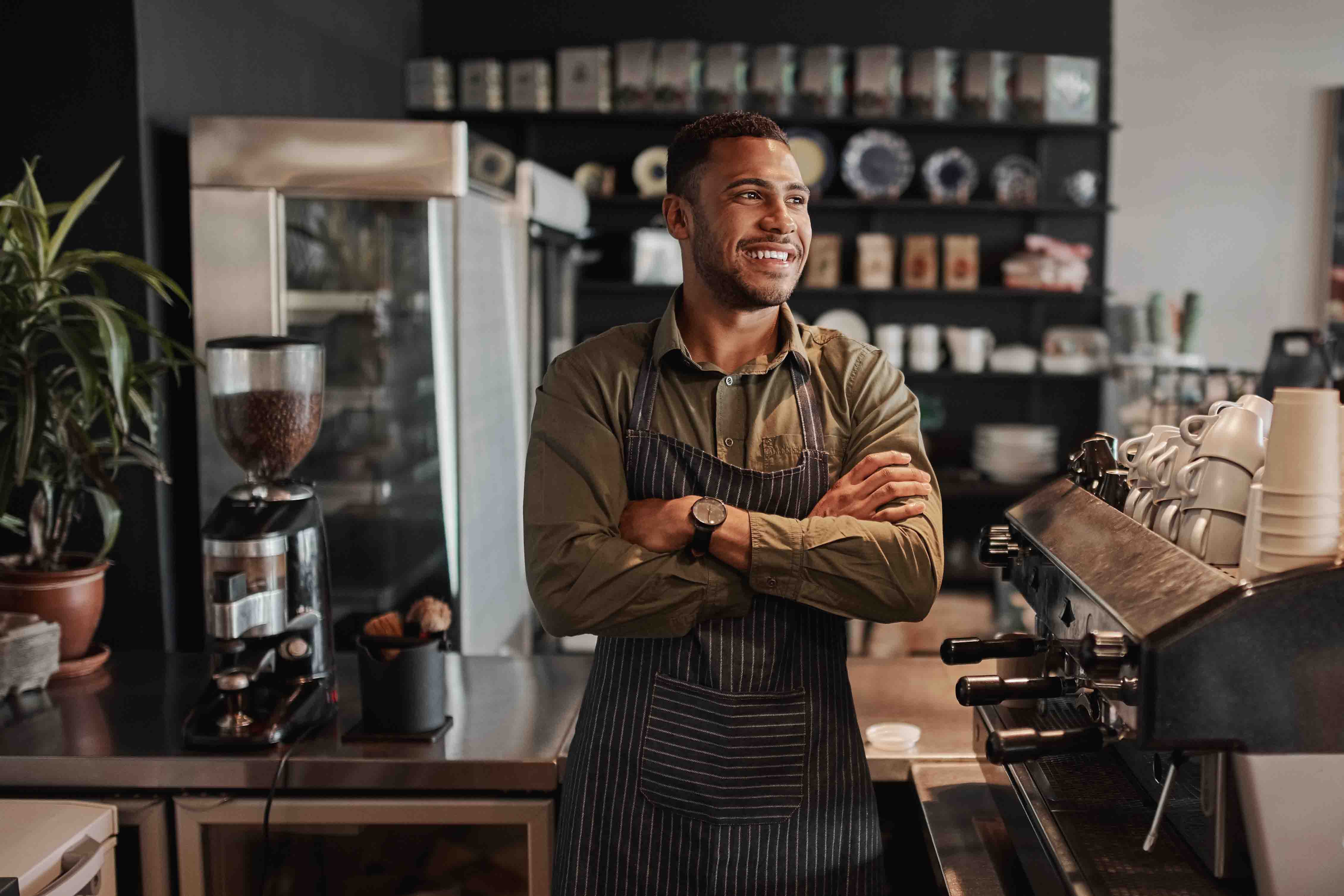 A man behind the counter at a coffee shop