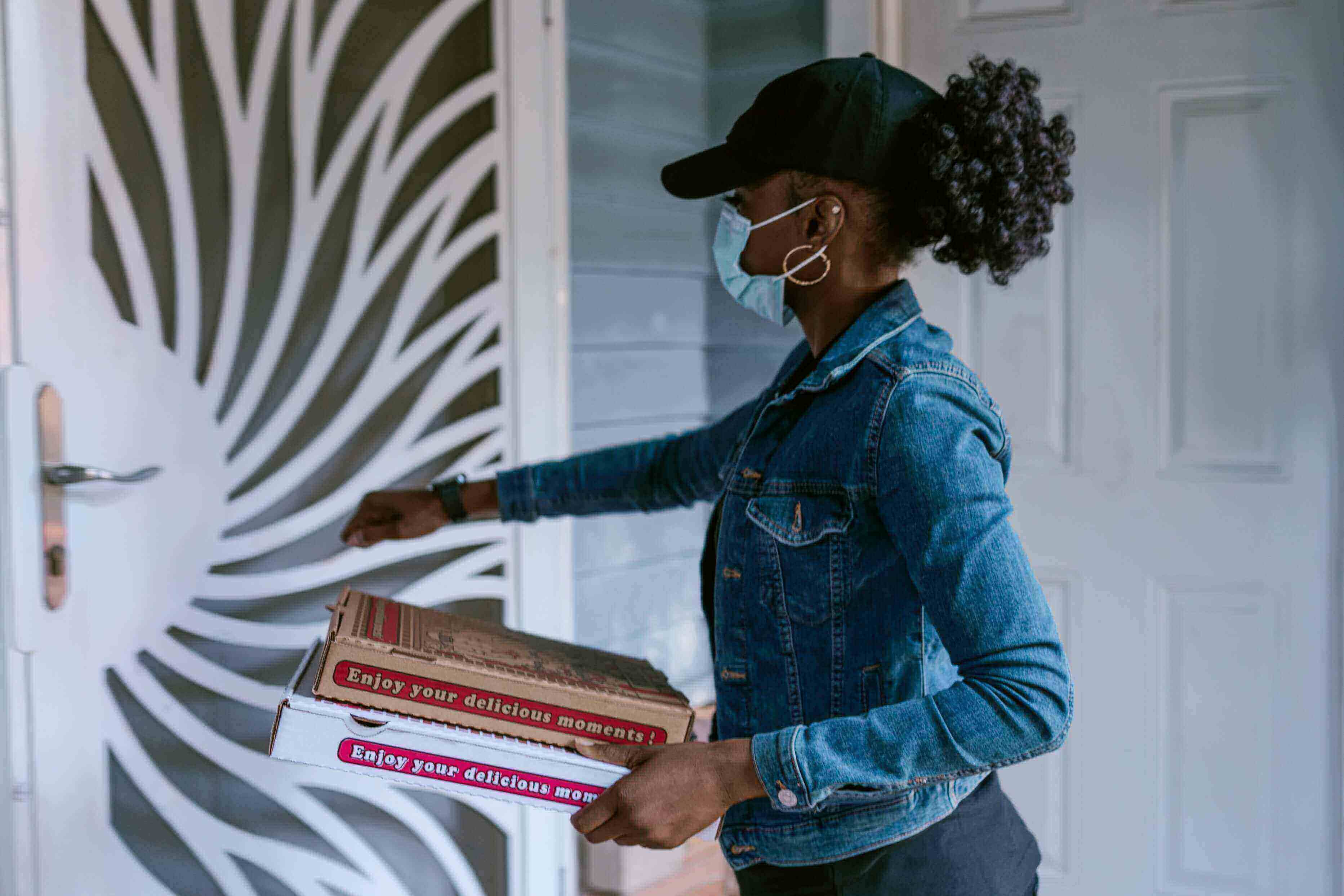 A woman delivering pizza from a delivery app