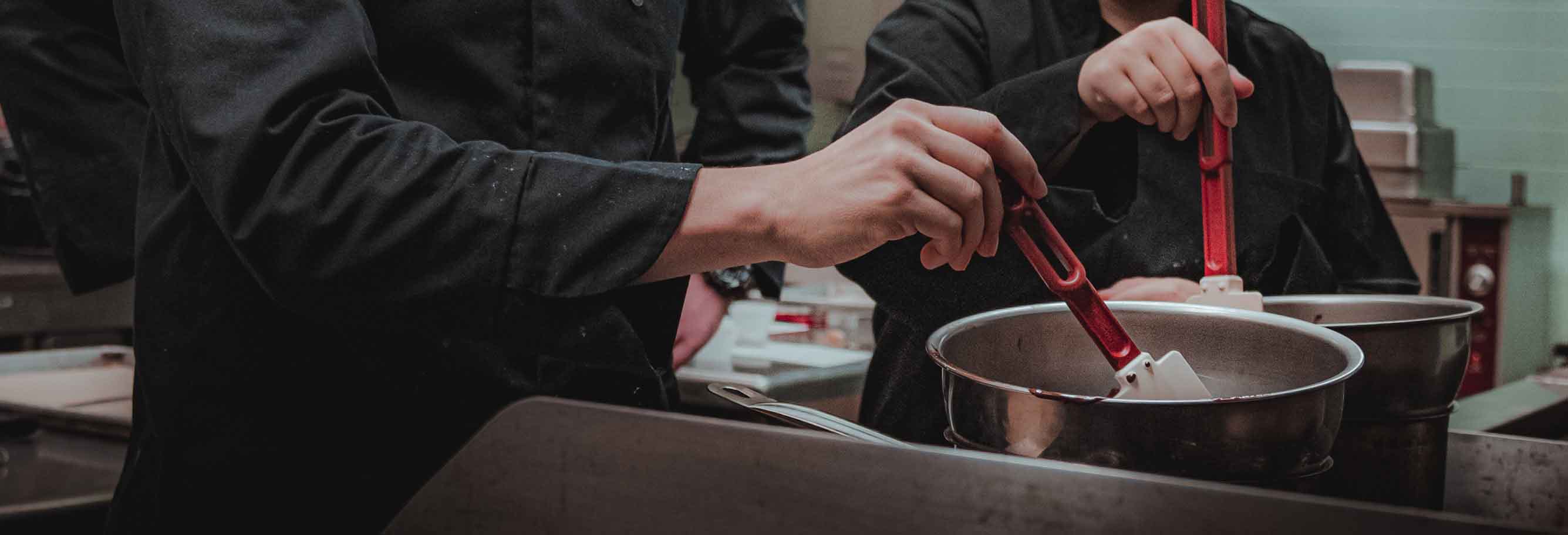 Two people working in a restaurant kitchen