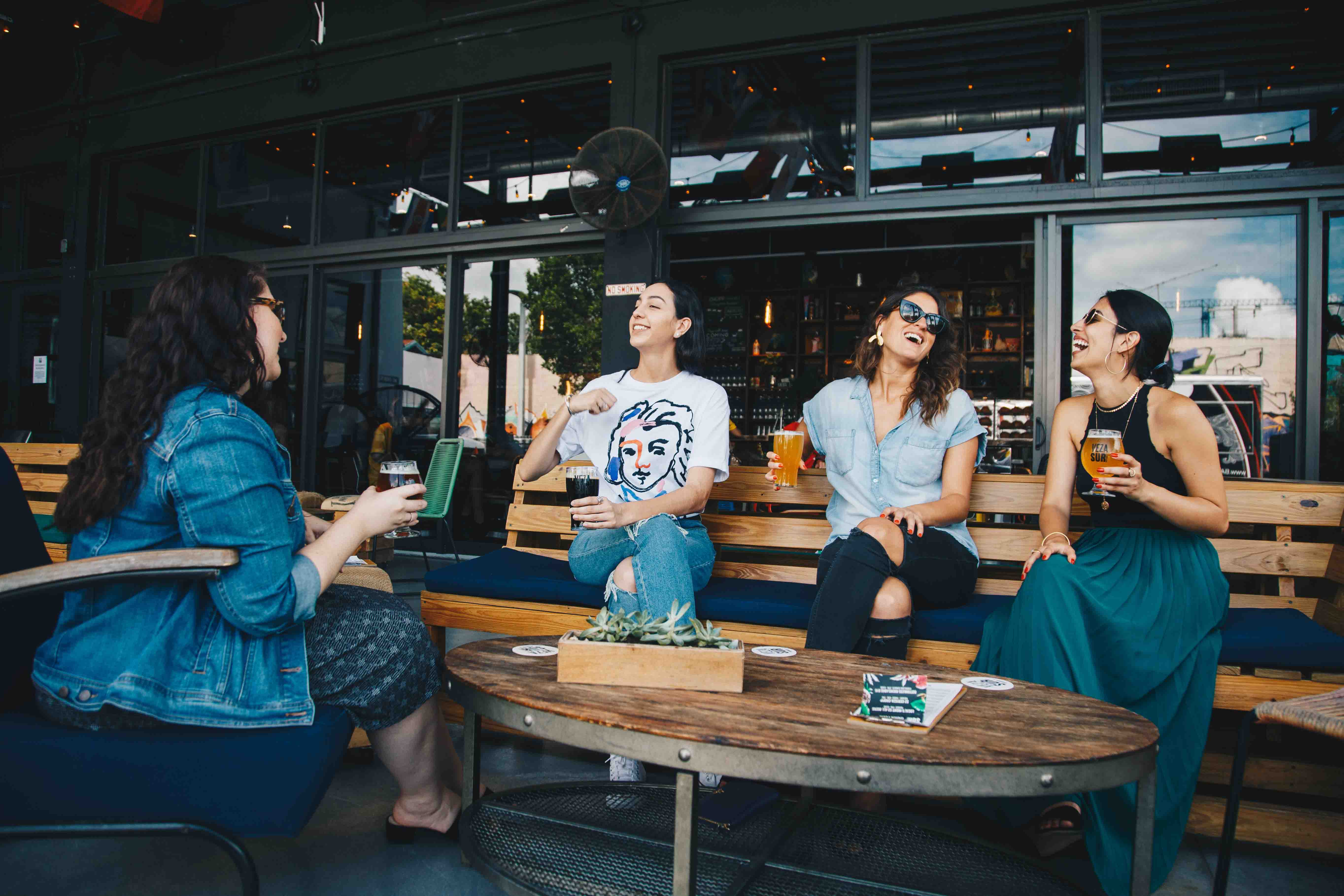 Woman talking and holding drinks at a restaurant